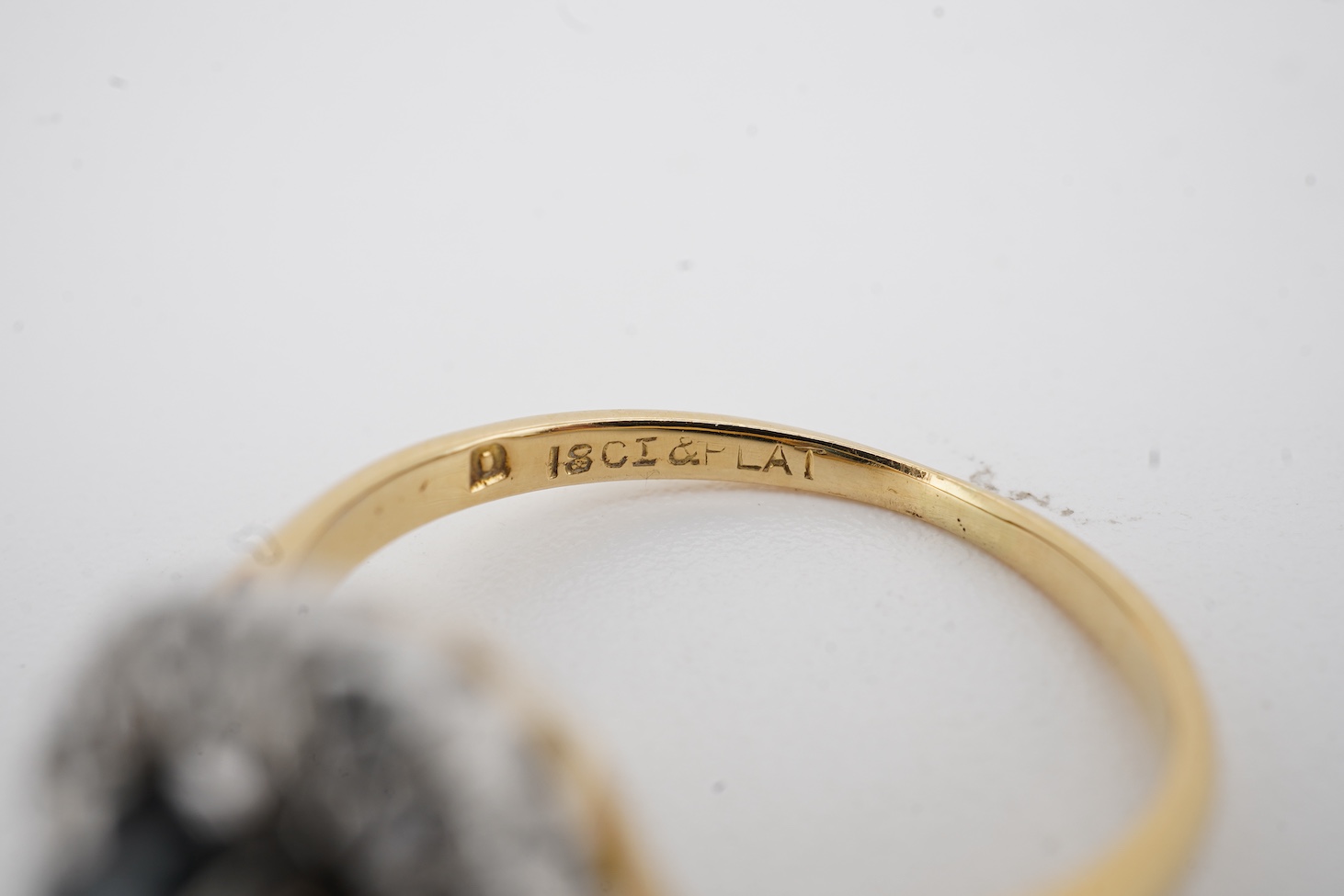 A mid 20th century 18ct and plat, sapphire and diamond set oval cluster ring, size K, gross weight 2.9 grams.